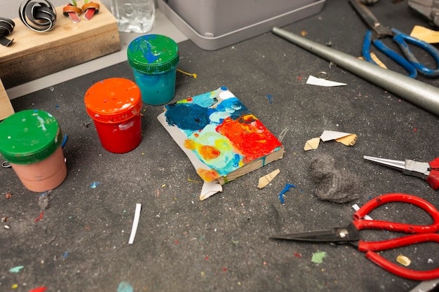 A well-organized workbench with all the necessary tools and materials for paint chip repair, including touch-up paint, fine-tipped brushes, rubbing compound, polishing cloth, wax, and cleaning solution.