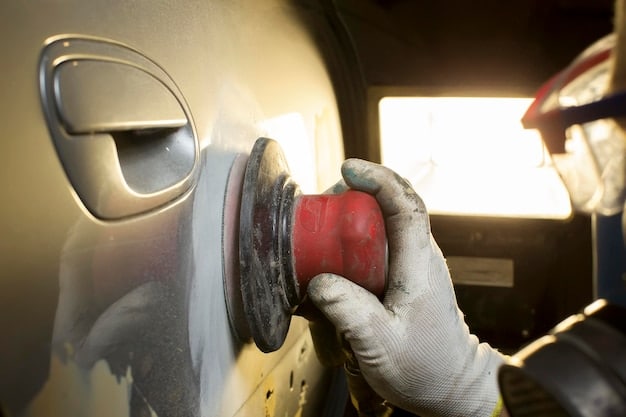 A person wearing gloves carefully polishing a car door with a machine polisher. The scene shows a garage setting with professional lighting, emphasizing the detail-oriented nature of paint preparation.
