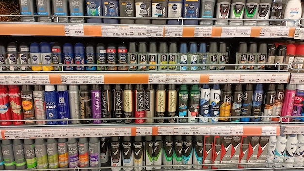 A variety of tire shine products arranged neatly on a garage shelf, showcasing different brands, types (gels, sprays), and sizes.