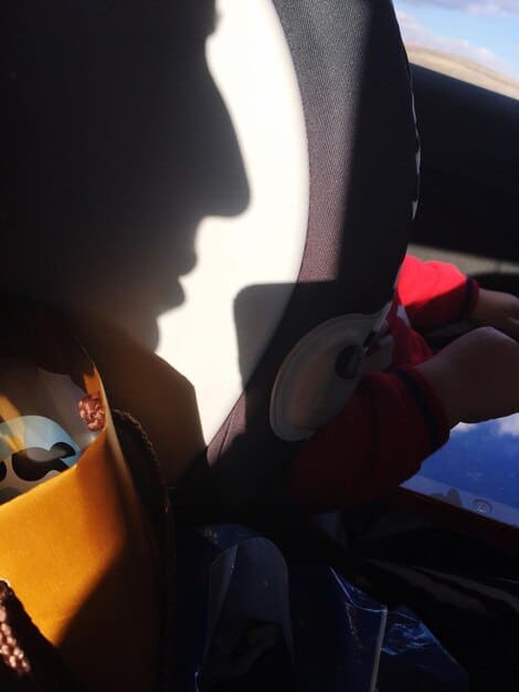 Sunlight streaming through a car window onto a leather seat, visibly fading one section compared to the rest.