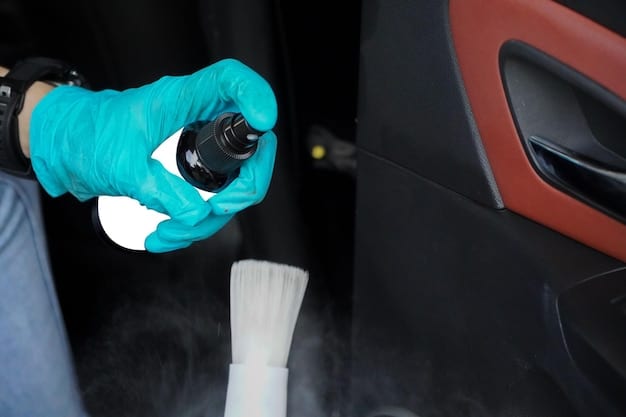 A technician carefully applying ceramic coating to a car panel in a well-lit detailing bay. The technician is wearing gloves and using professional application tools to ensure even coverage and optimal bonding.