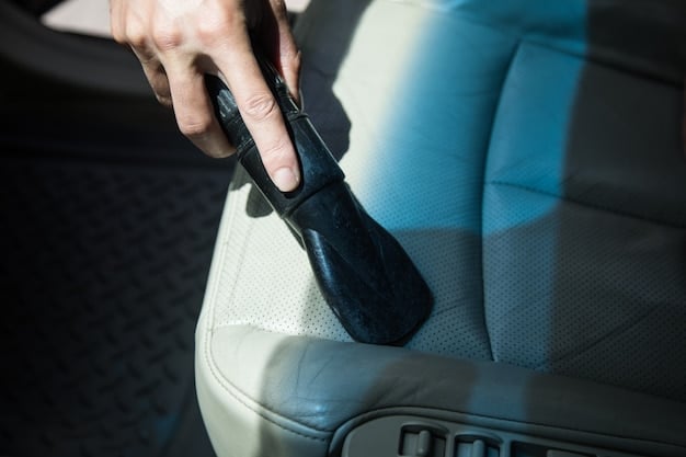 A close-up shot of a car's interior being cleaned and detailed. The focus is on the detailing professional using specialized tools to clean crevices and surfaces, ensuring a spotless finish.