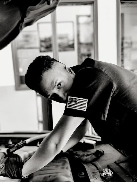 A close-up shot of a car mechanic inspecting a car's engine. The mechanic is using diagnostic tools to check the engine's performance. The image emphasizes the importance of regular maintenance and service checks.
