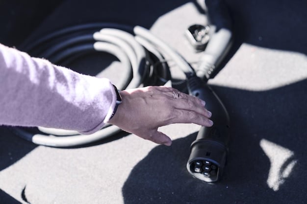 A close-up shot of a hand plugging an electric vehicle charging cable into a car. The charging station is sleek and modern, with a digital display showing the charging status. Focus on the details of the charging port and cable.