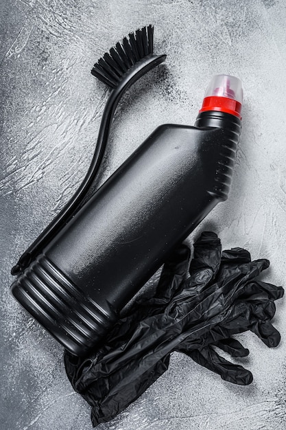 A collection of car detailing supplies organized neatly on a table, including microfiber cloths, detailing brushes, interior cleaner sprays, and a handheld vacuum cleaner.