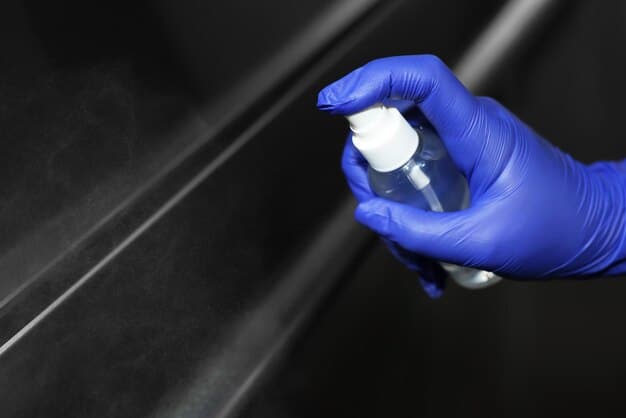 A detailed shot of quick detailer spray being applied to a car's fender, with a microfiber towel ready for buffing to illustrate maintenance.