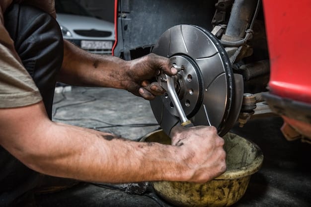 A mechanic using a caliper to measure the thickness of a brake pad. The brake pad is still attached to the brake caliper on the car. This image demonstrates a key step in How to Inspect Your Car's Brake Pads for Wear and Tear in Under 30 Minutes (2025 Edition).