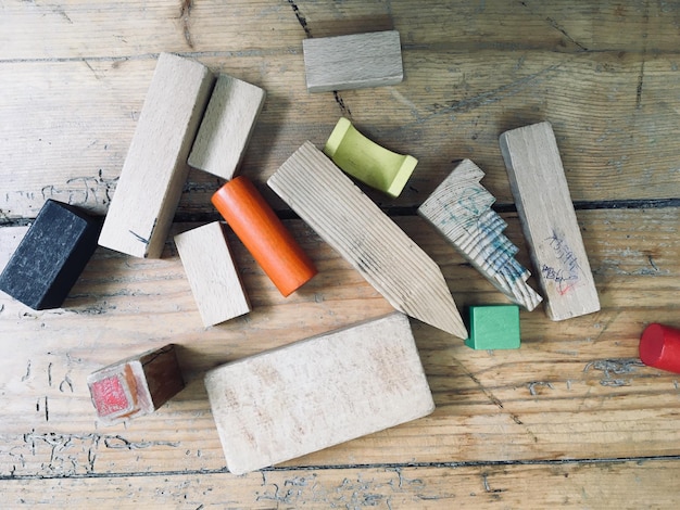 A collection of materials laid out on a workbench, including various grits of sandpaper, masking tape, headlight restoration compound, microfiber cloths, and a spray bottle. The arrangement is neat and organized, emphasizing the readiness for a DIY project. Highlights materials for DIY Headlight Restoration: Get 50% Brighter Lights for Under $20.