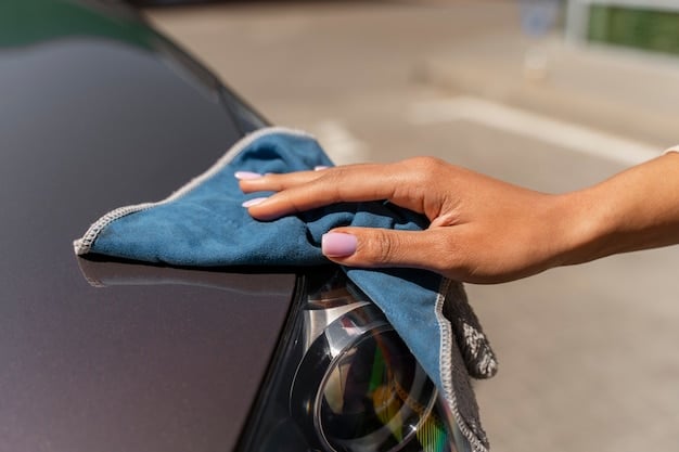 A person's hands gently buffing a car's surface with a microfiber cloth after applying scratch removal compound. The focus is on the smooth, even strokes and the clean, polished appearance of the paint. This illustrates the final step in DIY Car Scratch Repair: Remove Minor Scratches at Home for Less Than $15.
