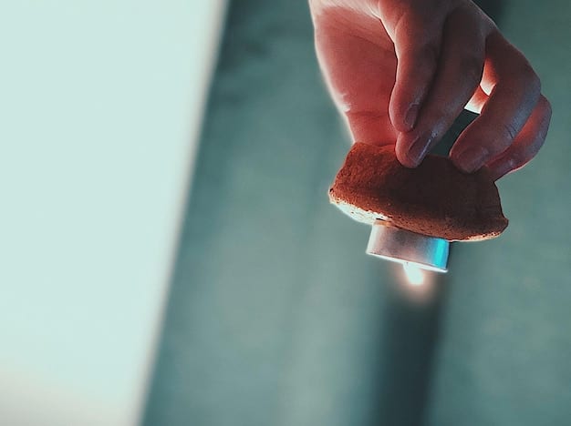 A close-up shot of a hand applying car wax to an applicator pad. The focus is on the texture and consistency of the wax, highlighting its quality and ease of use in DIY Car Waxing: Protect Your Car's Paint and Enhance Its Shine.