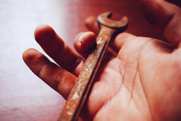 Close-up shot of a person using a wrench to loosen the bleeder screw on a car's brake caliper. The focus is on the bleeder screw and the wrench. Brake fluid is visible around the screw. This image illustrates a key step in DIY Car Brake Bleeding: Improve Braking Performance and Safety.