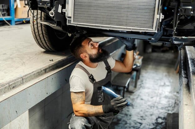 A mechanic using a specialized machine to perform a coolant flush on a vehicle's radiator. The image highlights the advanced equipment used during the service to ensure complete removal of old coolant and proper refilling with new coolant related to Extend Your Vehicle's Life: Get 20% Off Fluid Flush Services During Our April Maintenance Event.
