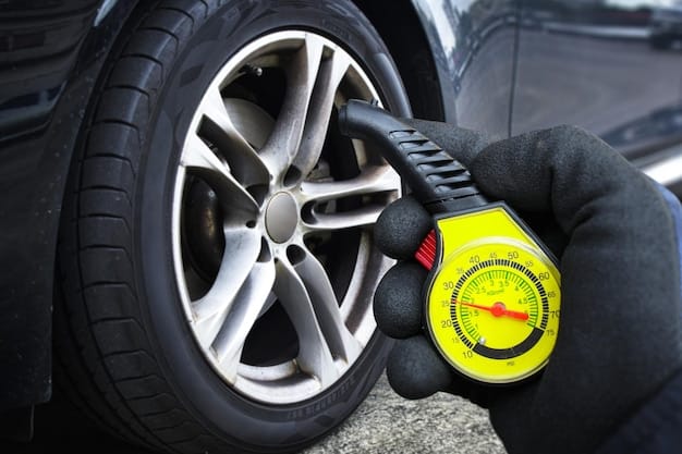 A set of car tires with a tire pressure gauge attached. The focus of the image is on the tire tread and the digital display of the pressure gauge. The setting is a sunny summer day outside of an auto shop, highlighting the importance of tire maintenance during the summer months for 'Is Your Car Ready for Summer? Get a Pre-Summer Inspection and Receive a $25 Service Credit'.