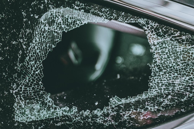 A close-up shot of a deployed airbag with visible tears and fragments. The image illustrates the potential dangers of a faulty airbag, highlighting the risk of injury from flying debris. The lighting emphasizes the torn edges and the texture of the airbag material.
