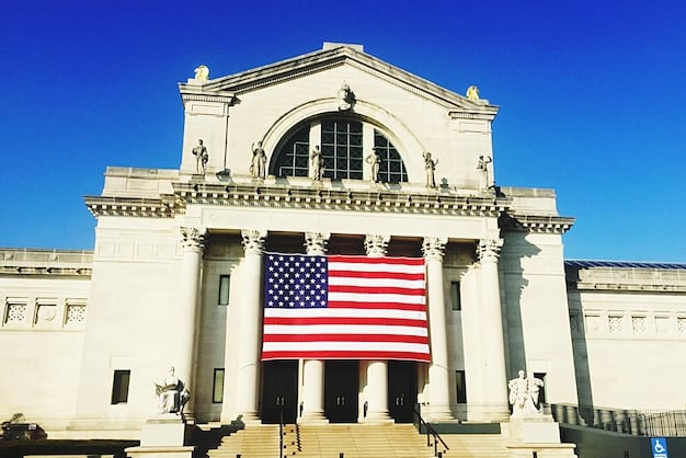 A government building with the American flag waving in front, symbolizing the regulatory bodies involved in overseeing autonomous vehicles, reinforcing the article's focus on Are Autonomous Vehicles Finally Here? Latest Updates on Self-Driving Car Regulations in the US.