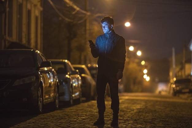 A nighttime surveillance shot showing two figures in dark clothing tampering with a parked car. The lighting is low, emphasizing the secretive nature of the activity. The scene is set from a slightly elevated angle, suggesting a security camera's perspective. The figures reflect the increasing car theft activity.