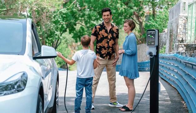 A diverse group of people standing around an electric vehicle, with a charging station visible in the background and a city skyline in the distance. The image represents the widespread adoption and accessibility of electric vehicles in the US, emphasizing the shift as Electric Vehicle Market Share Reaches 20% in the US: A Turning Point?.