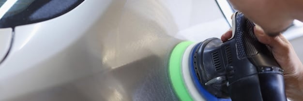 A close-up shot of a car’s surface being polished with a machine polisher. The focus is on the polishing pad making contact with the paint, with the light reflecting off the polished area. The image should convey precision and care. Mention 'How to Remove Stubborn Water Spots After a Car Wash: A 5-Step Guide for 2025' in the description.
