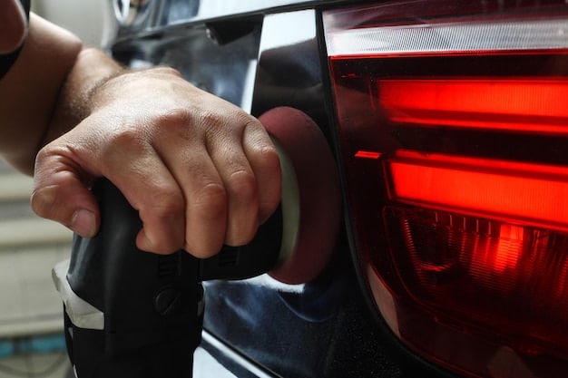 A close-up view of a hand applying ceramic coating to a car panel using a specialized applicator. The hand is wearing a glove, and the panel is prepped and glossy. The focus is on the smooth, even application and the tools used in the process. This illustrates the careful technique used in Ceramic Coating vs. Wax: Which Protects Your Car's Paint Longer in 2025?.