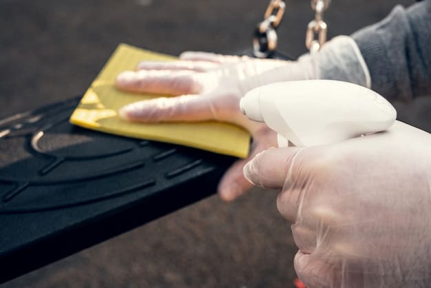 A person using a detailing clay bar on a car door, with a spray bottle of lubricant and a clean microfiber towel nearby. The focus should be on the technique and the tools used.