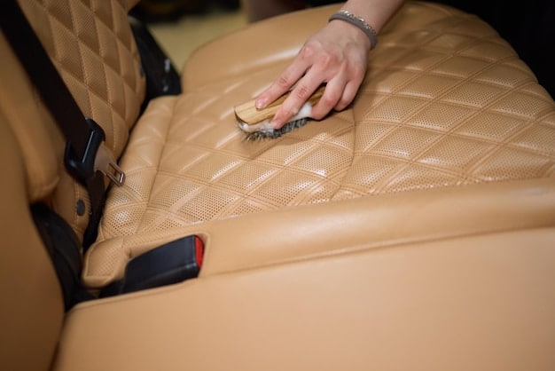A close-up shot showing the application of a leather conditioner to a new car seat. The image highlights the rich, moisturized appearance of the treated leather, emphasizing the importance of interior protection in new car detailing.