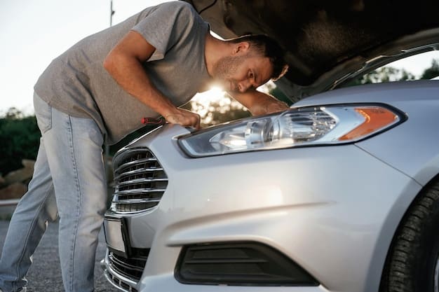 A person sanding a cloudy car headlight with sandpaper, showing the initial stages of removing the oxidation. The headlight is visibly yellowed around the area being sanded. Headlight Restoration: How to Improve Visibility by 75% with DIY Detailing is a focus.