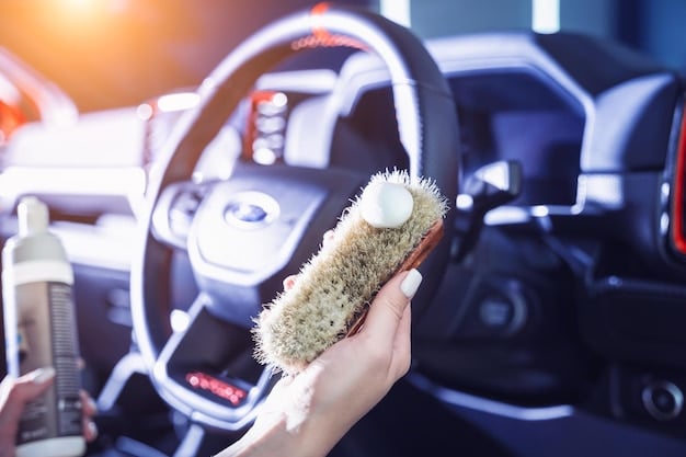 A person using a soft-bristled detailing brush to gently clean the dashboard of a car. The focus is on the brush's bristles making contact with the dashboard surface, lifting dust and grime, demonstrating the effectiveness of 'The 5 Best Car Detailing Brushes for a Spotless Clean in 2025'.