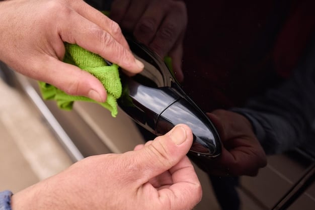 A person using a detailing brush and interior cleaner to clean the dashboard of a car. The focus is on the detailing brush removing dust and grime from the crevices and the interior cleaner bottle.  Car Detailing on a Budget: Top 10 Products Under $20 That Deliver Results.
