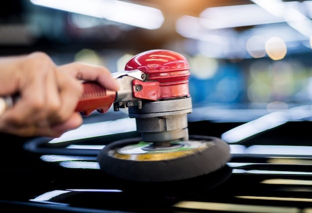 A side-by-side comparison of a dual-action polisher and a rotary polisher. The photo highlights the differences in their design and the types of pads that can be used with each. The setting is a professional detailing shop.
