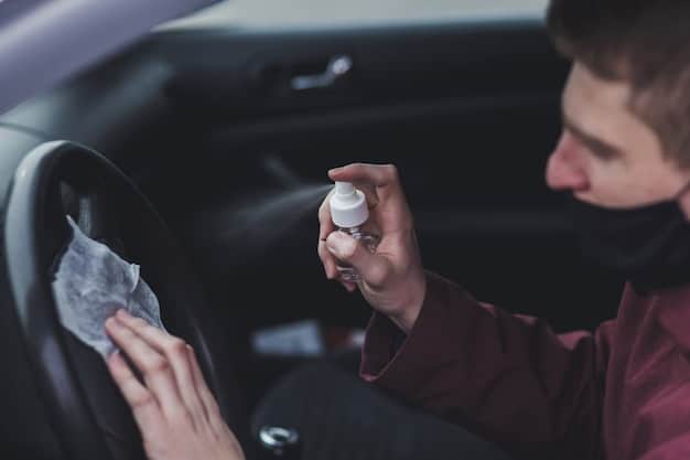 A person carefully cleaning the dashboard of a car with a soft brush and detailing spray, emphasizing the importance of gentle and thorough cleaning to protect the material.