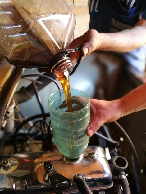 A mechanic carefully pouring fresh engine oil into a car's engine during an oil change service, emphasizing cleanliness and precision.